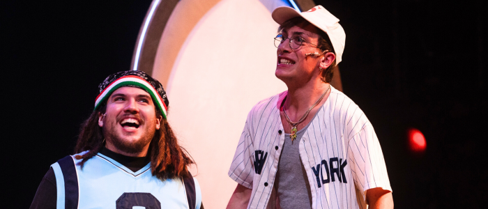 Rebels One & Two (Vincenzo Faruolo & Sol Ramirez) smiling big in sports jerseys for Connecticut Rep's production of The Old Man and The Old Moon (Fall 2024).
