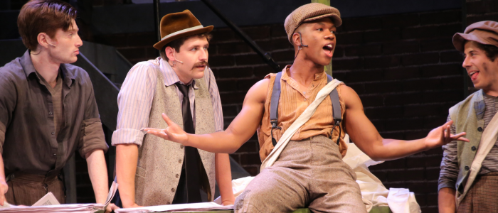Young men from Newsies, dressed in bedraggled clothing.