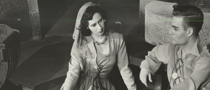 In one of CRT's productions from 1955, a man and a woman look longingly at each other while sitting on the floor in a scene from The Lady's Not for Burning.
