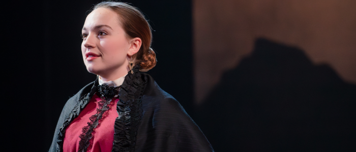 The the 2024 production of The Moors, Agatha (played by Kat Corrigan) wistfully stares out toward the audience as she contemplates a different life.