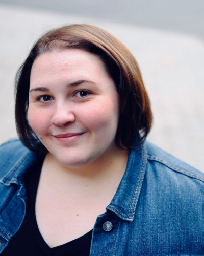 Portrait of Alison Savino, a white woman with short straight brown hair, wearing a denim shirt