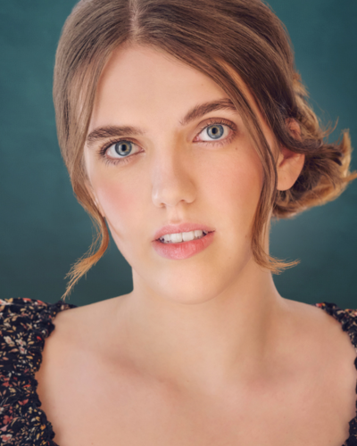 Portrait of Ella Neiwoood, a white college student with dark blonde hair pulled back.