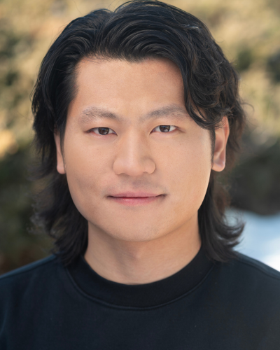 Portrait of Jaihui Guo, an Asian graduate student with wavy black hair and dark t-shirt