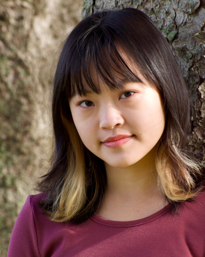 Porrait of Jordan Au, an Asian college student with bangs and medium legnth straight dark hairwith blond tips.