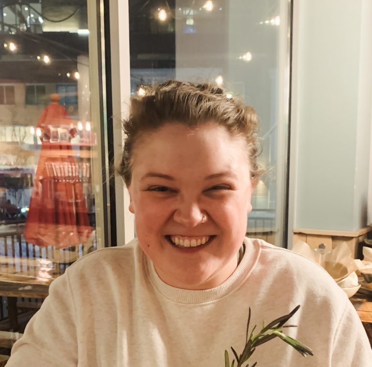 Portrait of a friendly, smiling woman with a white t-shirt