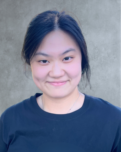 Portrait of an Asian graduate student with dark hair in a ponytail, wearing a dark blue t-shirt.
