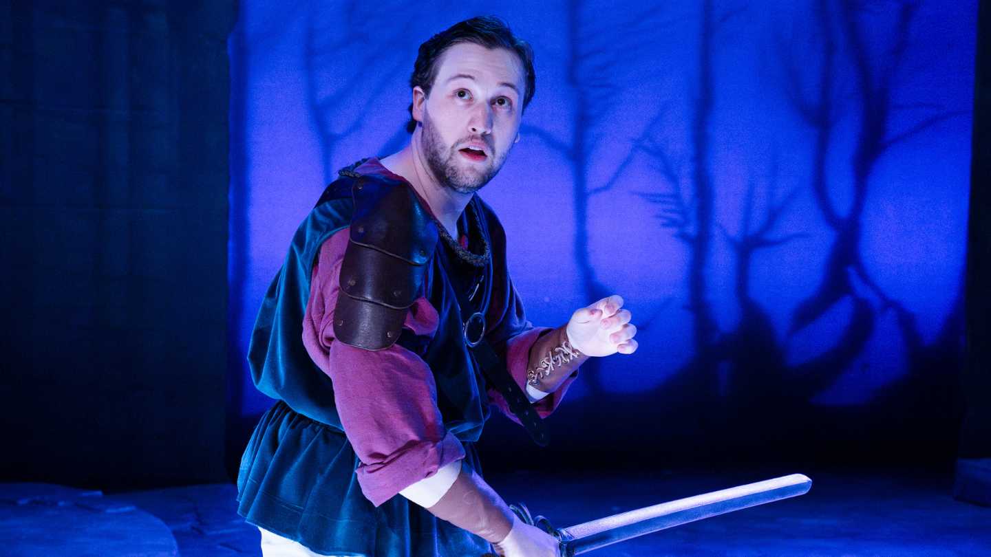 A frightened Horatio holds a sword to defend himself from the Zombies