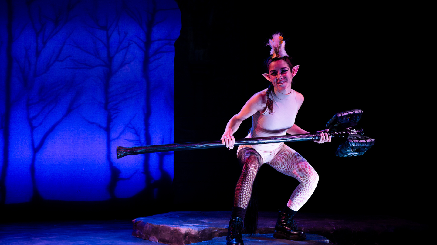 A mischievous Puck searches out her next victim, weapon in hand.