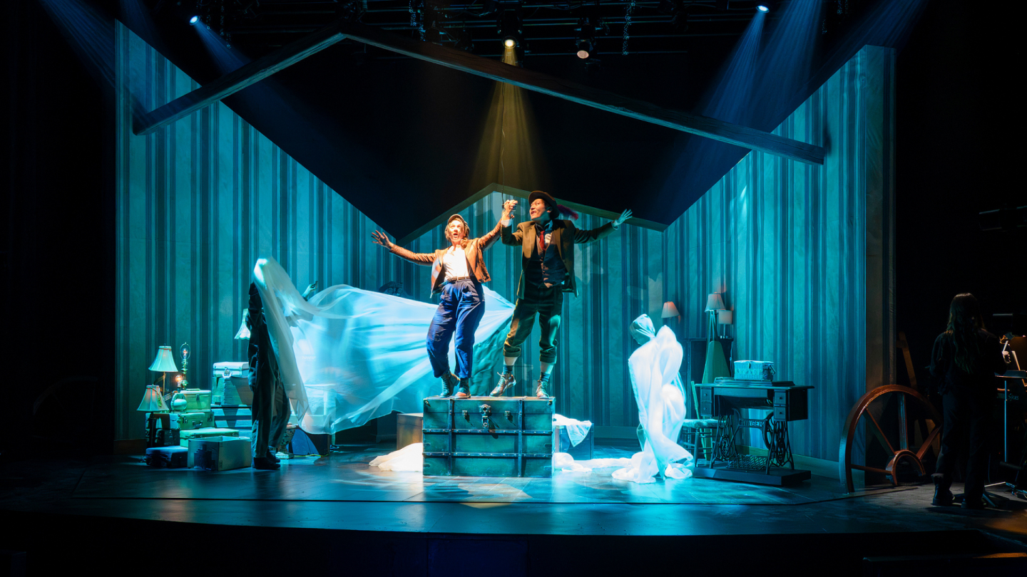 Wendy and Peter make believe they are on an ocean voyage as the stand on top of the huge trunk