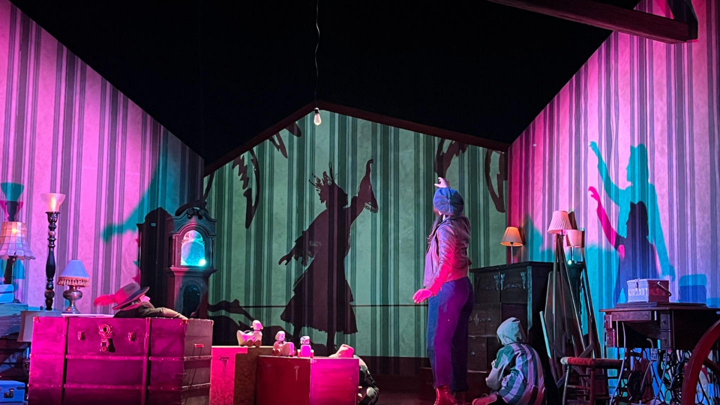 Bathed in pink and blue light, Wendy sees Darling- a silhouette of her younger self.