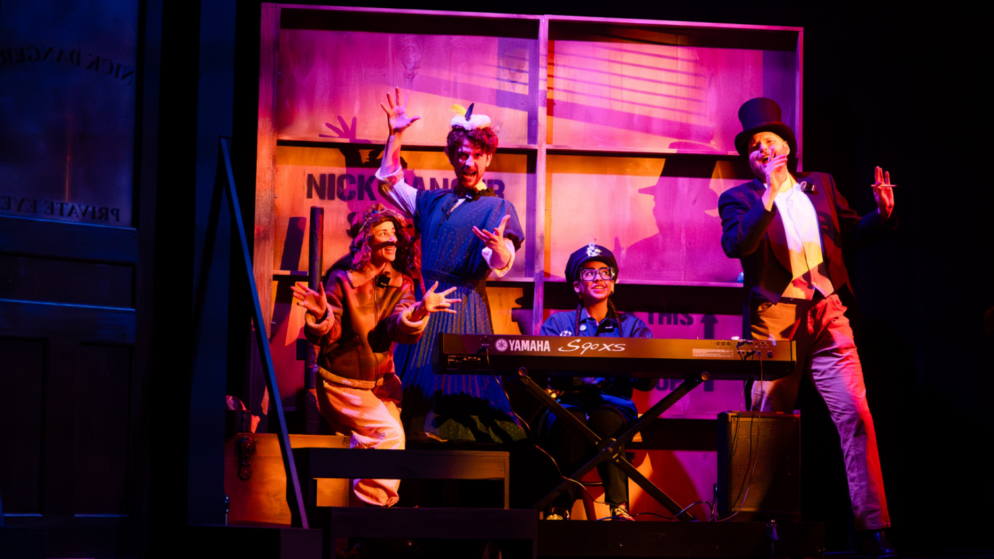 Nick Danger archive 2 In a scene from Nick Danger, Third Eye, the ensemble sings out while drenched in pink light.