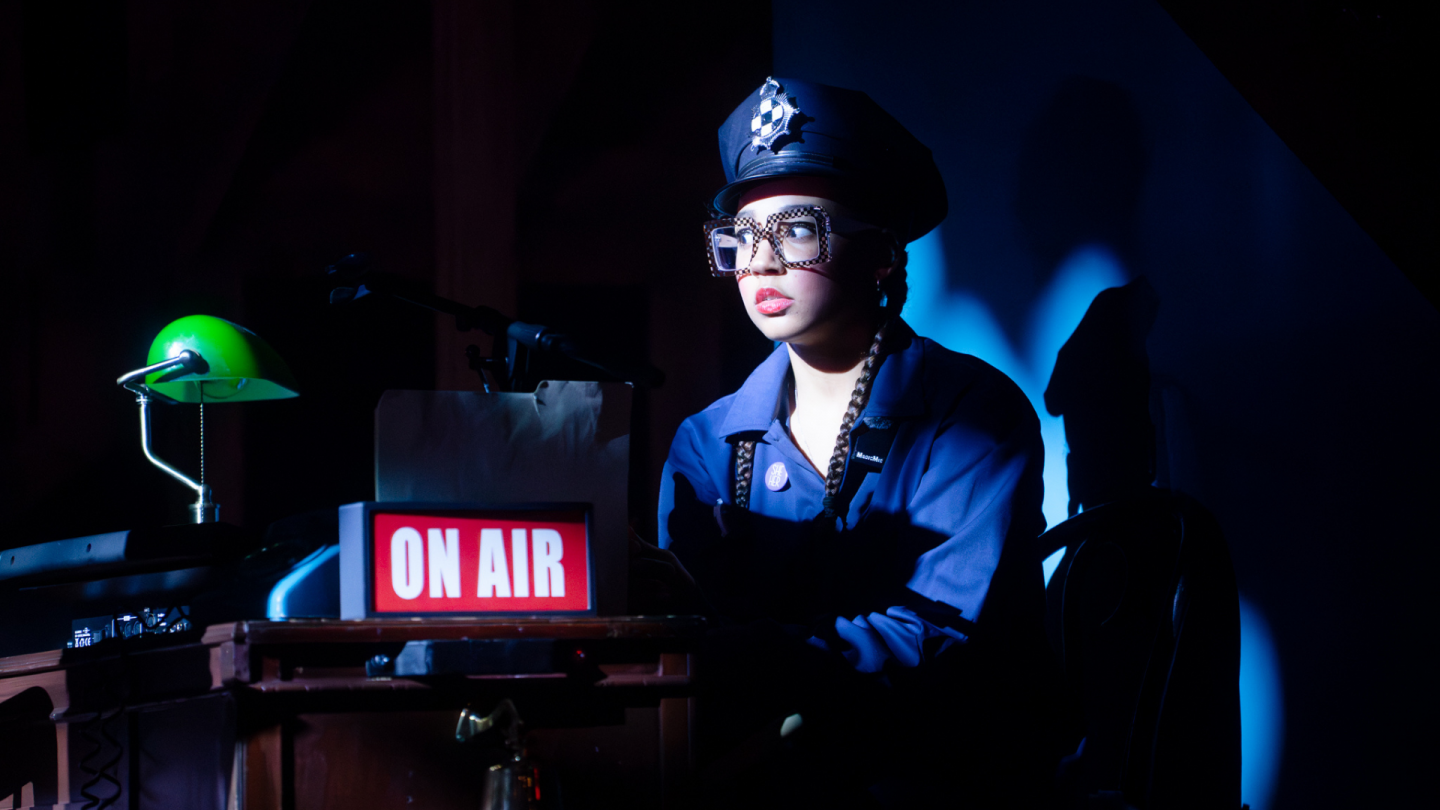 Nick Danger archive 8 In a scene from Nick Danger, Third Eye, a police officer wearing large square glasses looks on.