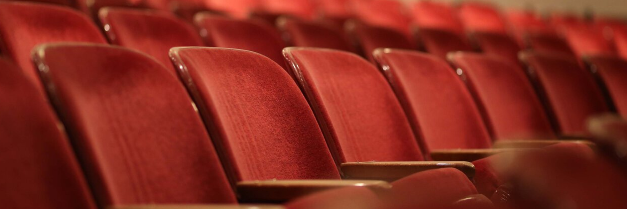 Row of empty red theater seats